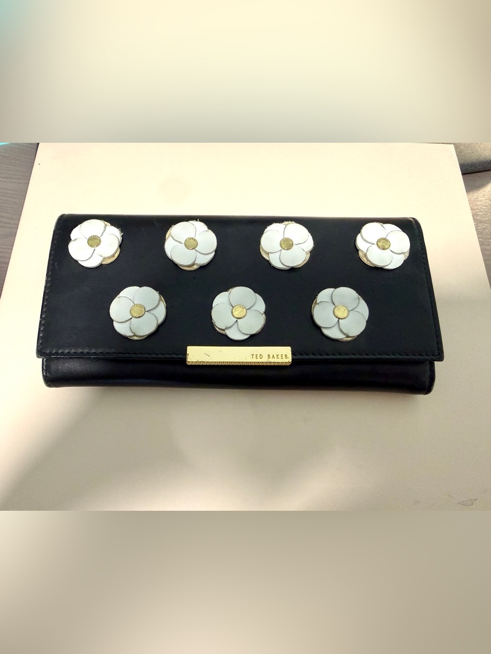 Ted Baker Black Clutch with White Floral Appliqués and Gold Plate